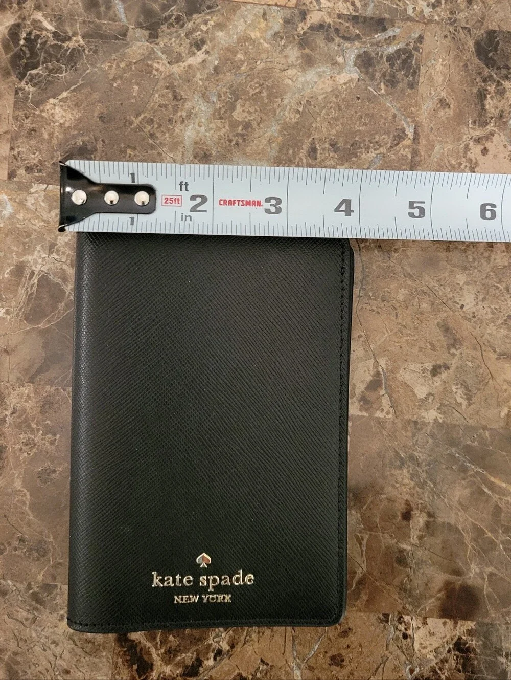kate spade black saffiano passport wallet with gold logo